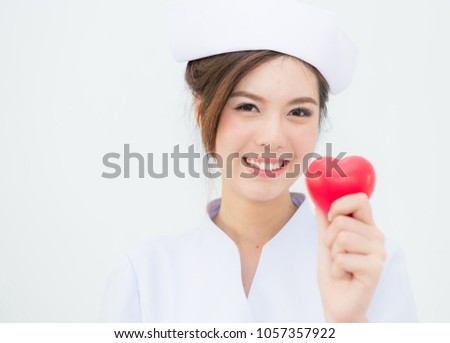 Portrait of female doctor or nurse holding heart isolated on white background,Nurse hold red heart shape,Health care professional doctor or nurse woman,World health day,Healthcare and medical concept,