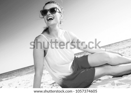 Colorful and wonderfully cheerful mood. happy modern woman in sunglasses and colorful dress on the seacoast looking at copy space