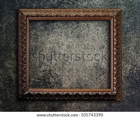 Old picture frame on grunge wall.