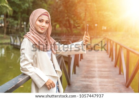Veiled student with sunlight background