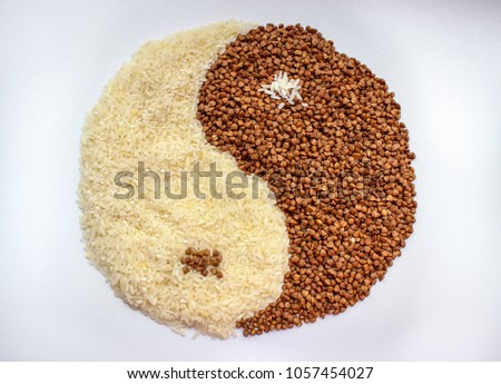The symbol of yin yang is laid out of buckwheat and rice, texture.