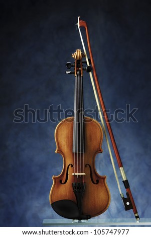 violin with bow on blue background