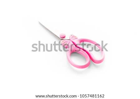 Pink scissors on a white background
