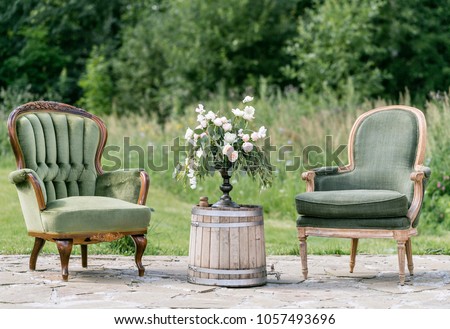 Vintage wood chairs and table with flower decoration in garden. outdoor