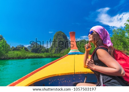 Traveler woman in summer dress relaxing on wooden boat joy view of Phang Nga bay, near Phuket, Travel in nature place Thailand, Beautiful destination Asia, Summer holiday outdoor vacation travel trip
