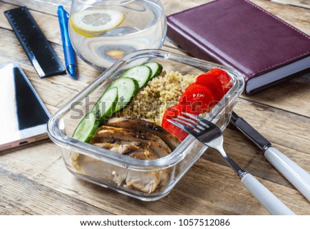 Healthy meal prep containers with quinoa, chicken and arugula Selective focus