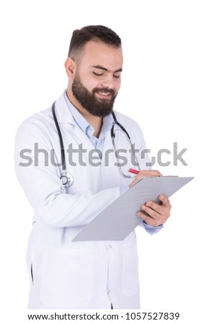A young standing doctor writing on the clipboard, isolated on a white background.
