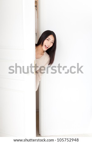 attractive asian woman opening door