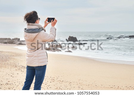 Woman takes a photo on her smartphone