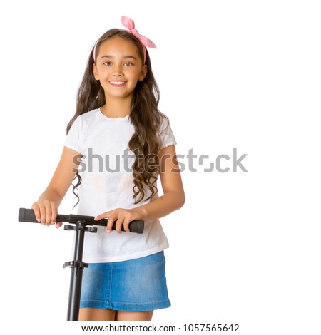 Beautiful teen girl is riding a scooter. The concept of summer vacation, advertising of sports goods. Isolated over white background