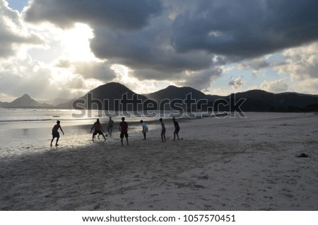 Lombok, Indonesia, guys in the evening on the beach playing football