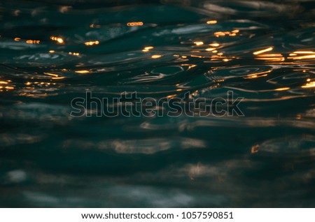 Abstract photo of hard sun light reflex on the pool is showing the fantastic various wave line texture.
