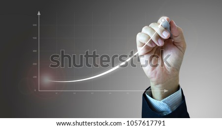Close up of a businessman's hand drawing an exponential line curve showing of business growth and success rapidly. Royalty-Free Stock Photo #1057617791