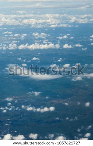 Farms in Holland, Netherlands with canal viewed from plane in sky, Europe with clouds
