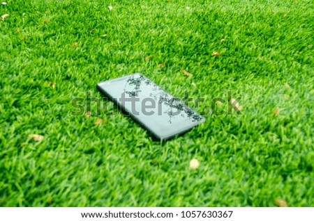 smartphone mobile isolated on green grass lawn background with copy space