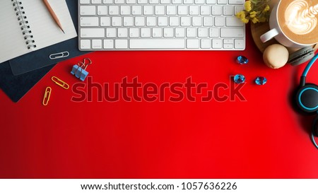 Styled stock photography red office desk table with blank notebook, keyboard, macaroon, supplies and coffee cup. Top view with copy space. Flat lay.