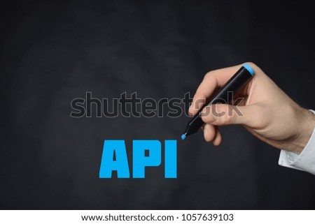 The businessman writes a blue marker inscription:API
