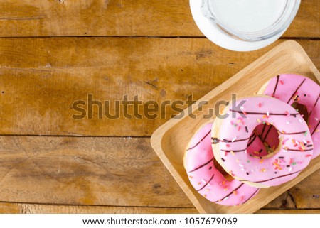 donuts with milk on wooden table