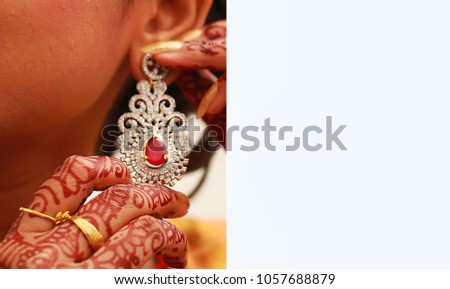 Beautiful earrings and hands of the bride