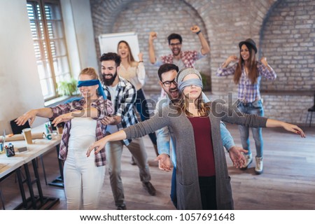 Business people making team training exercise during team building seminar, play a game of trust Royalty-Free Stock Photo #1057691648