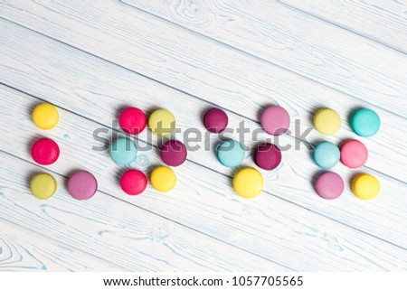 Bright Almond cookies are laid out on a light wooden background