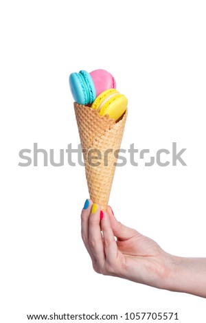 Almond cookies in waffle cone on white background
