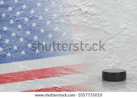 Hockey puck and the image of the American flag on the ice. Concept, hockey