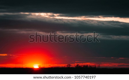 A beautiful sunset on the embankment of the city of Khabarovsk with beautiful textured images and a bloody sun