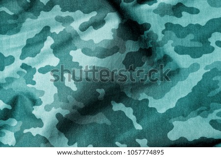 Military uniform pattern in cyan tone. Abstract background and texture.