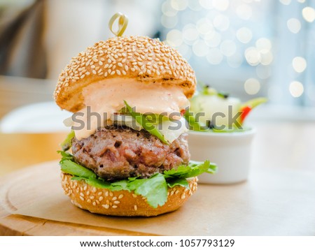 burger with a large chop and white sauce