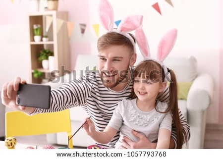 Father taking selfie with his daughter on Easter