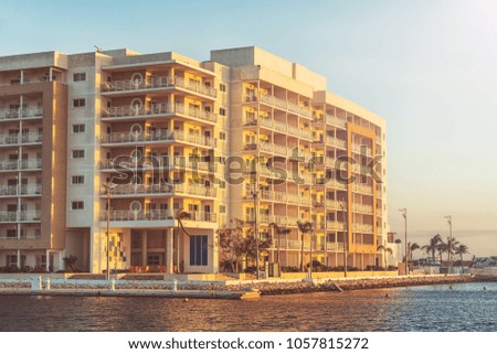 Picture of hotel building close to the sea at the sunset time