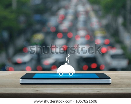 Restaurant cloche flat icon on modern smart phone screen on wooden table over blur of rush hour with cars and road, Food delivery concept