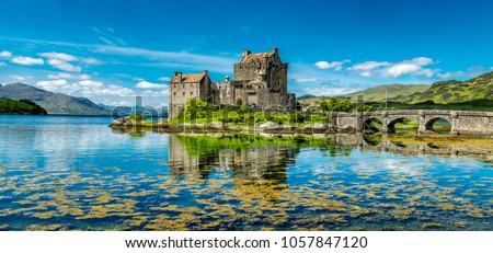 Eilean Donan Castle during a warm summer day - Dornie, Scotland - United Kingdom Royalty-Free Stock Photo #1057847120