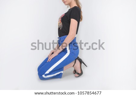 female legs in Leisure stripy blue jeans with black high hell shoes sitting posing 


