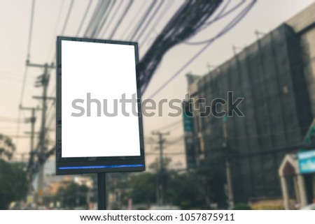 Billboard with white screen at bus stop for advertiser or notice.