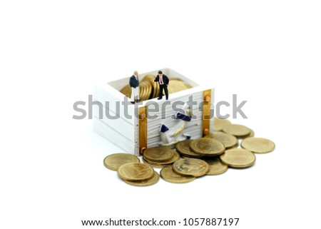 Miniature people : businessman with treasure coffer of gold.