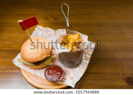 food to beer. hamburger and french fries with sauce