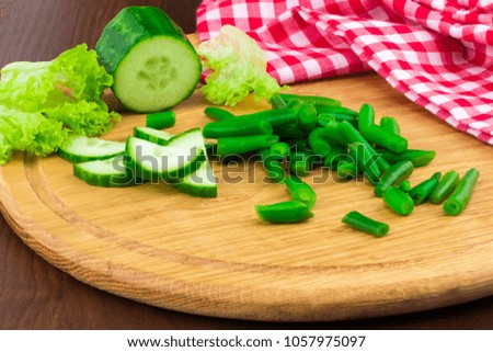 Fresh spring salad with cucumber, lettuce and green peas on a wooden Board with free text space.