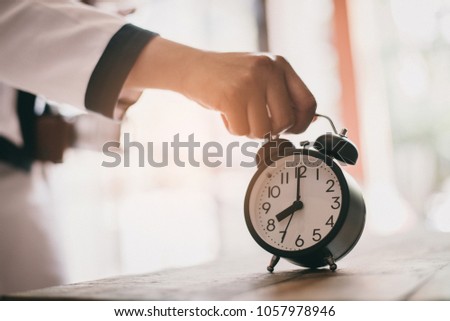 Vintage background with retro alarm clock on table, hipster concept.