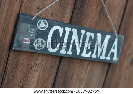 Vintage Sign cinema on a line in front of wooden old gate