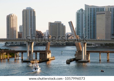 The view of a boat passing under the bridge with Brickell Key skyline in a background (Miami, Florida).