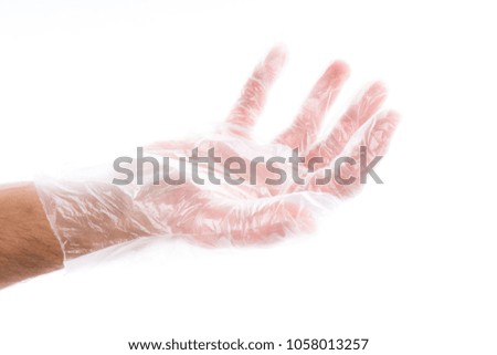 Side view of beautiful human hand palm dressed in new nice disposable plastic latex glove isolated on abstract white background. Wearing and special clothes concept. Detailed closeup studio shot