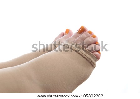 details of  feet of a pregnant woman with a compression stocking