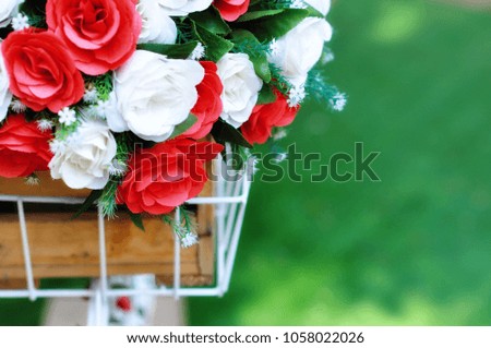 Beautiful bouquet of plastic flower in basket of bicycle. Concept is stable love and always beautiful. Picture is selective focus and soft style.