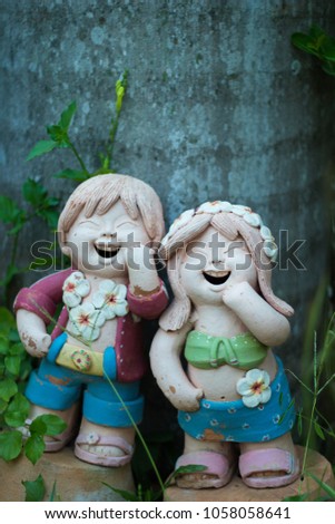 Statue of boy and girl standing smiling. Thailand