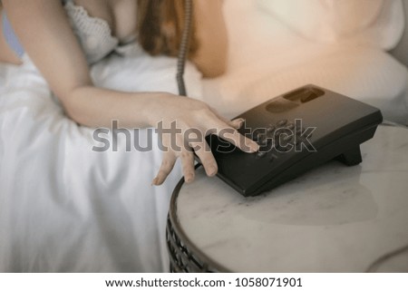 girl in body underwear lying on bed texting on  phone. Woman relaxing lazing in bedroom at the morning.