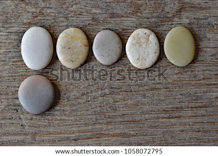 Six round grained grey pebbles