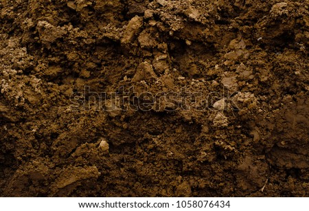 Texture of brown agrictultural soil Royalty-Free Stock Photo #1058076434