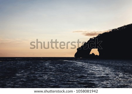 Malay, Country - January 09, 2016: sunrise with a rock formation creating a natural arch at the Boracay island on the city of Malay, Philippines.